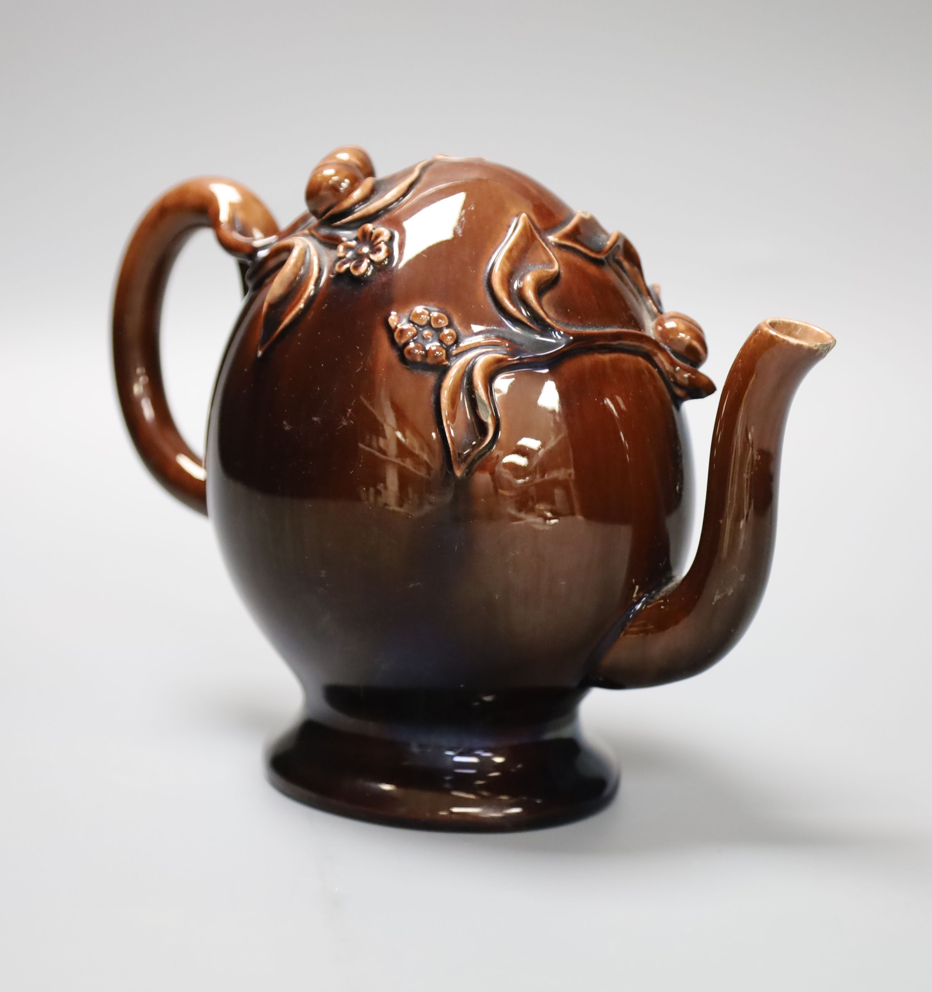 A small Brameld Cadogan teapot, relief moulded and gilded over a brown glaze, impressed mark, height 15cm, minor spout chip